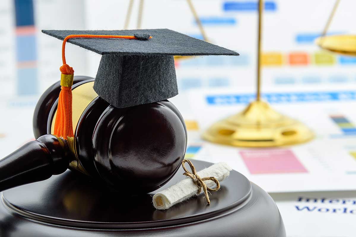 A graduation cap and diploma on top of a table.